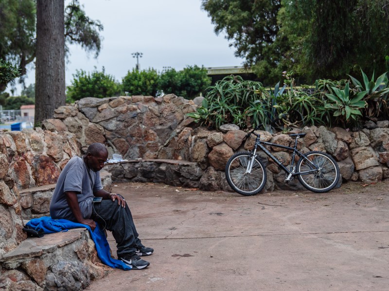 Dwayne Stephens who is homeless sits in a park near Old Town on July 17, 2024. / Ariana Drehsler for Voice of San Diego