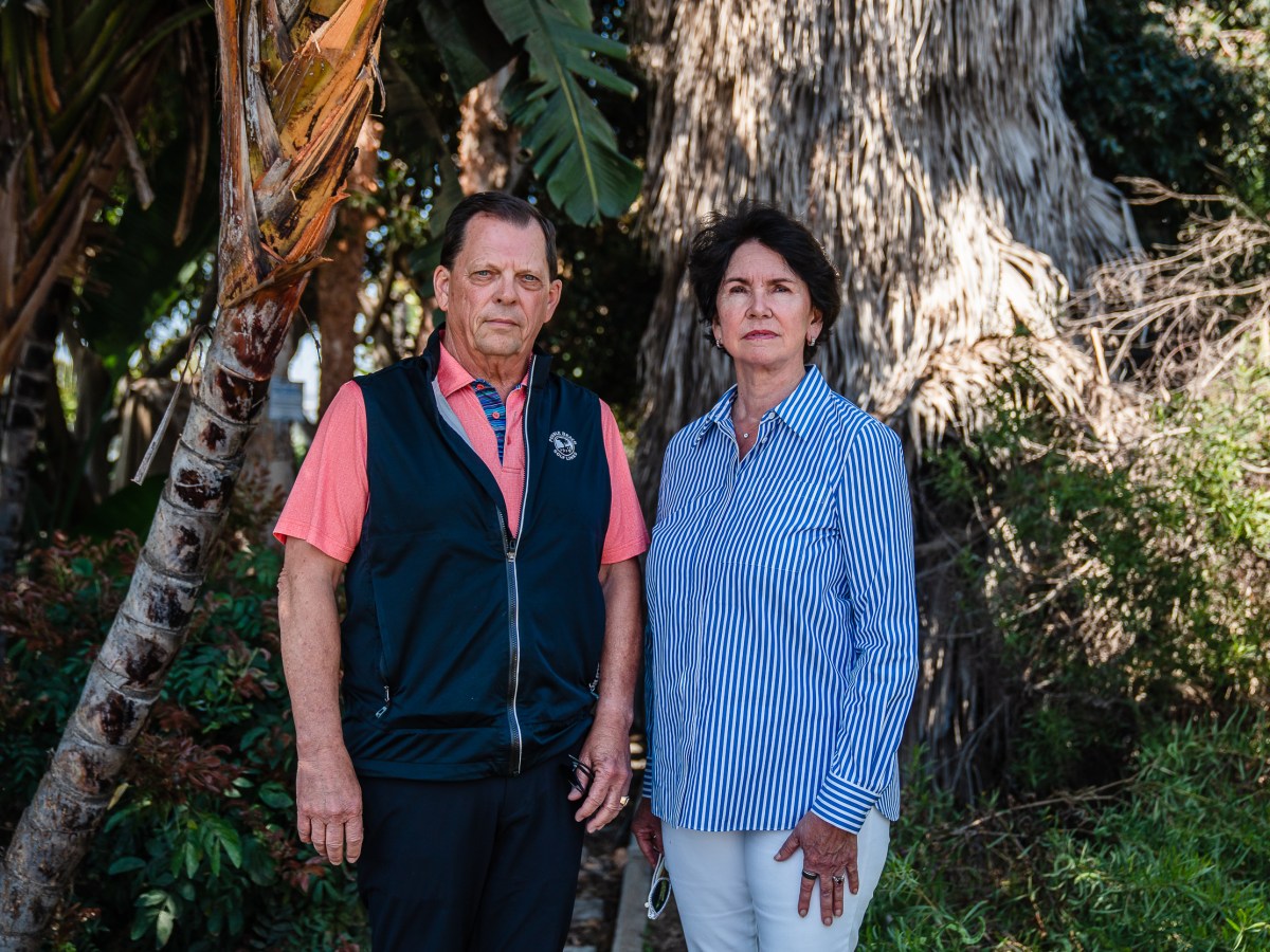 Scott McMillin and Ceci Doty stand near the H Barracks safe parking project near the San Diego International Airport on April 9, 2025. / Ariana Drehsler for Voice of San Diego